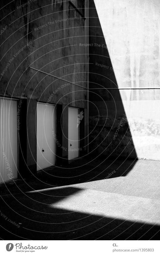 backyard Places Wall (barrier) Wall (building) Garage Garage door Dark Sharp-edged Gloomy Parking Parking lot Backyard Shadow play Black & white photo