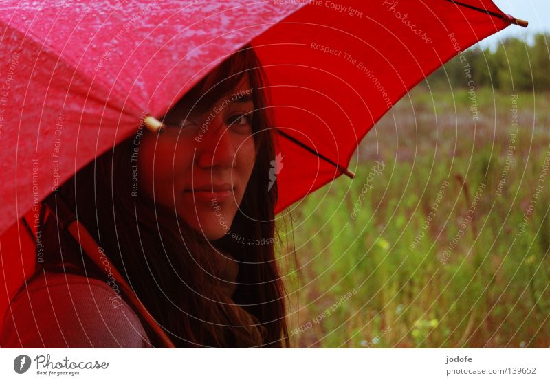 Bln 08 it's raining... Woman Youth (Young adults) Feminine Living thing Umbrella Wet Damp Rain Bad weather Friendliness Congenial Meadow Grass Fallow land Green