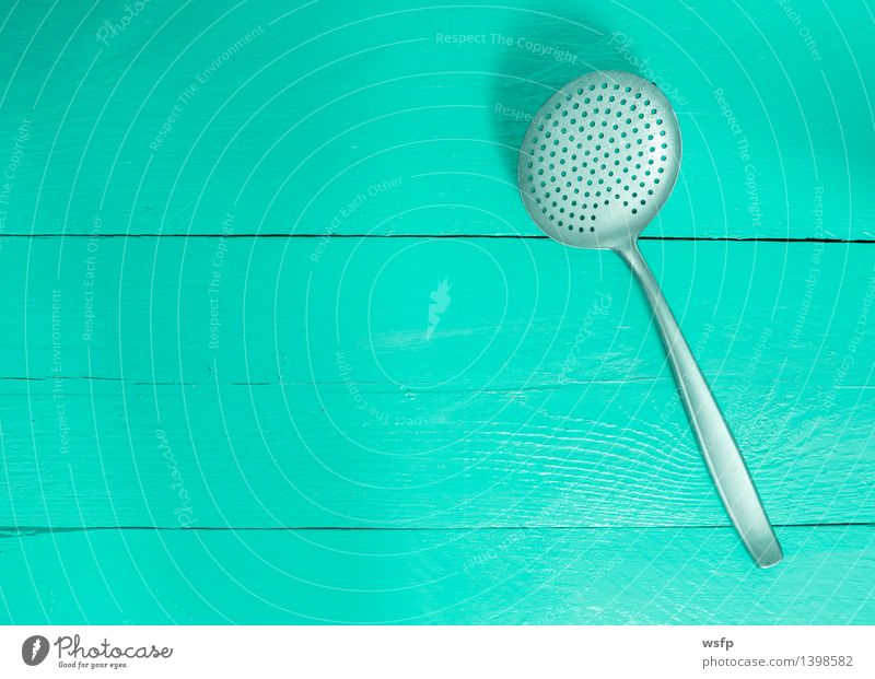 Drip ladle on turquoise wood as background Kitchen Restaurant Gastronomy Old Turquoise drain trowel dumpling trowel sieve trowel Wooden board Wooden table