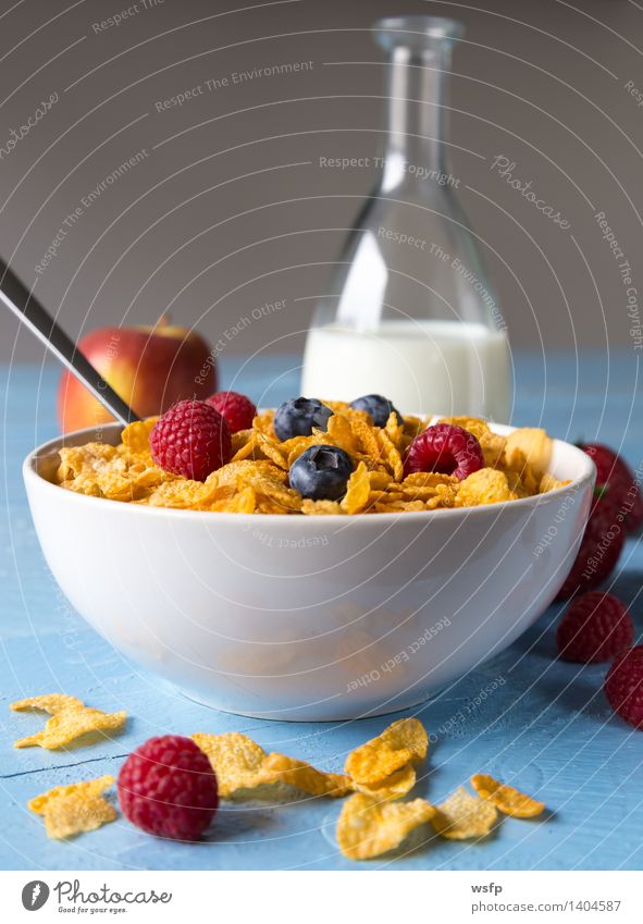 Cornflakes in a bowl Fruit Apple Breakfast Milk Bowl Wood Blue breakfast cereals Flake Blueberry Cereals raspberry Strawberry Grain Eating shell Blue background