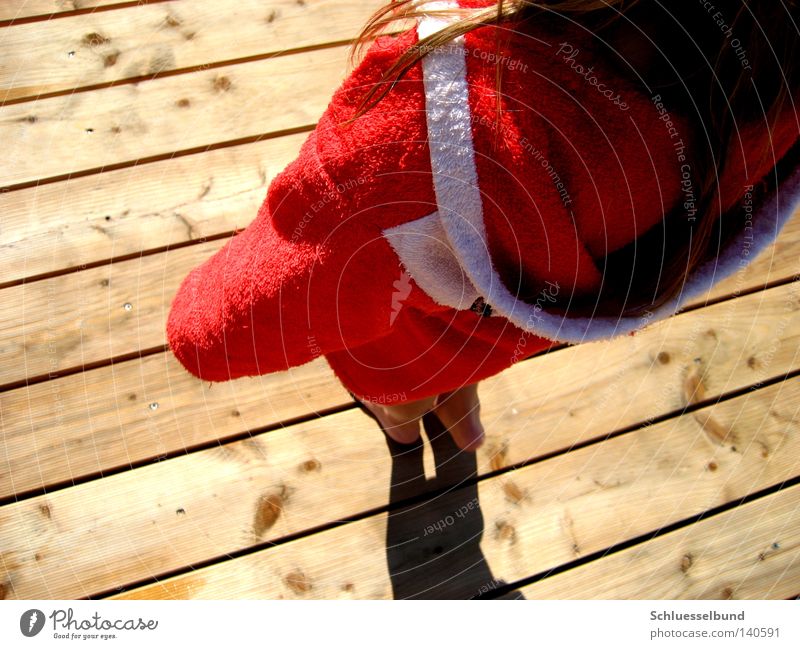 red coat Hair and hairstyles Leisure and hobbies Human being Woman Adults Feet Cloth Wood Stripe Dark Bright Red White Bathrobe Exterior shot Barefoot Stand