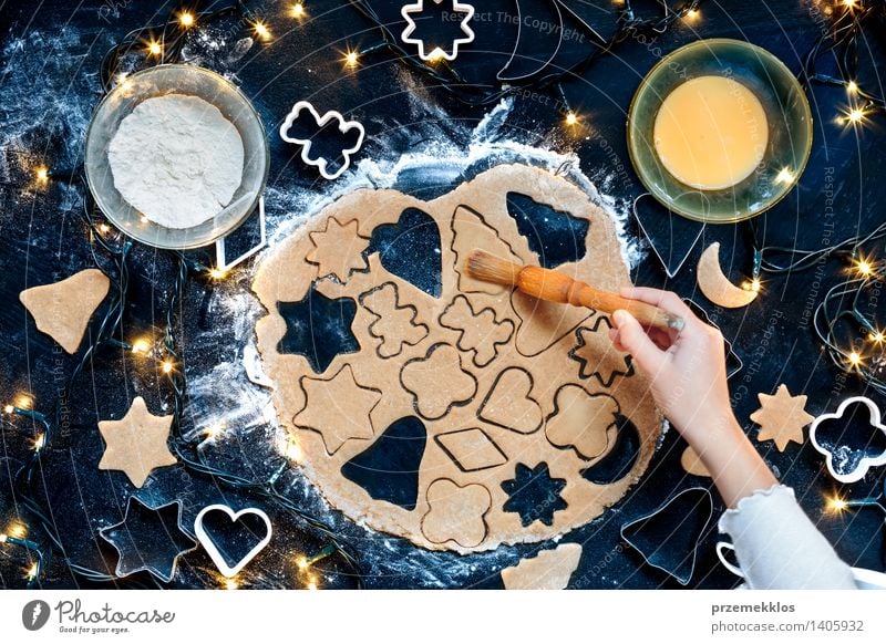 Girl making the Christmas cookies Table Kitchen Human being Hand 1 Make Cut Cutter Knife Egg Flour Gingerbread Home-made Preparation Colour photo Interior shot