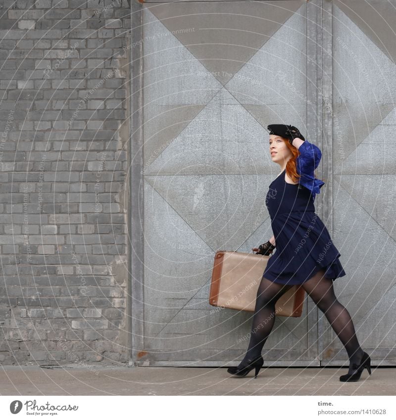 . Feminine 1 Human being Wall (barrier) Wall (building) Door Dress Jacket Tights Suitcase High heels Cap Stone Metal Brick Observe Going Walking Looking Elegant