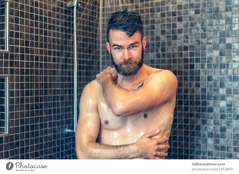 Friendly young man soaping himself in the shower Skin Face Wellness Bathroom Man Adults Beard Smiling Wet Clean at camera bath bathing care Caucasian chest