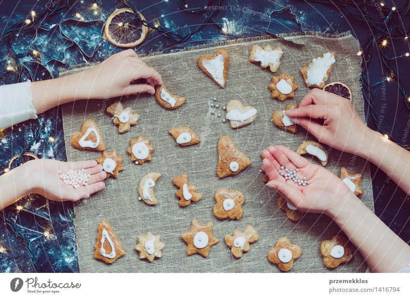 Mom with daughter decorating Christmas cookies Table Kitchen Human being Girl Woman Adults Hand 2 Make Cut Cutter Knife Flour Gingerbread Home-made Preparation