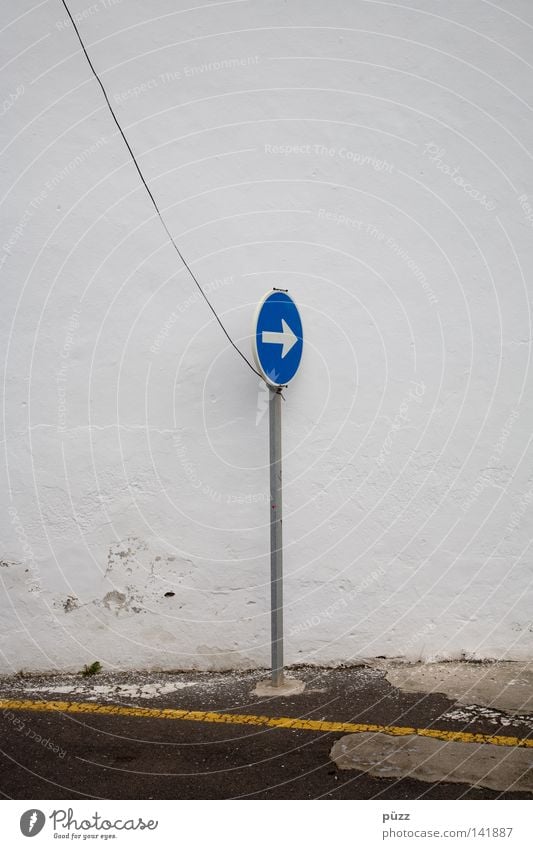 That way! Street Road sign Sign Signs and labeling Signage Warning sign Line Arrow String Blue Yellow White Wall (building) Steel cable Pole Street sign