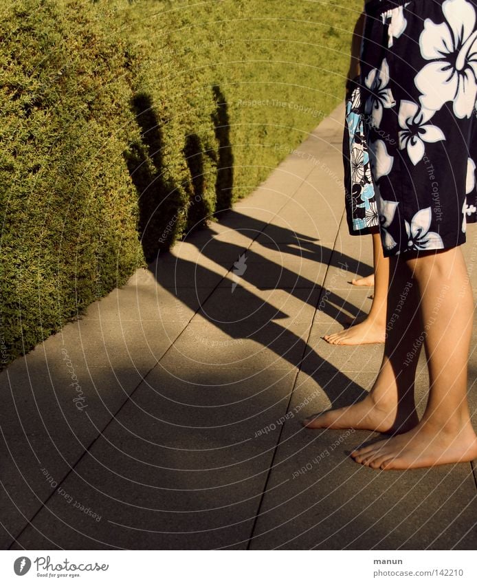 take a break Swimming pool Open-air swimming pool Child Boy (child) Swimming trunks Toes Break Appetite Shadow Evening sun Light Light and shadow Stagnating