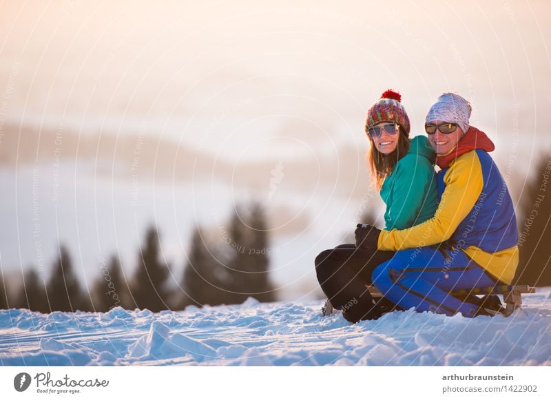 Winter twilight for two Lifestyle Joy Leisure and hobbies Snow Winter vacation Human being Masculine Feminine Young woman Youth (Young adults) Young man Parents