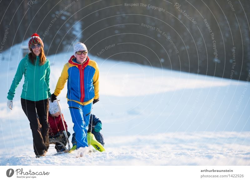 Young family with children go sledding in winter sunshine Leisure and hobbies Vacation & Travel Tourism Trip Winter Snow Winter vacation Human being Masculine