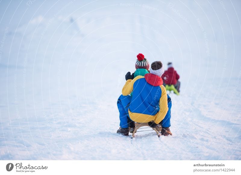 Family at the sleigh Joy Trip Winter Snow Winter vacation Winter sports Human being Masculine Feminine Child Boy (child) Young woman Youth (Young adults)