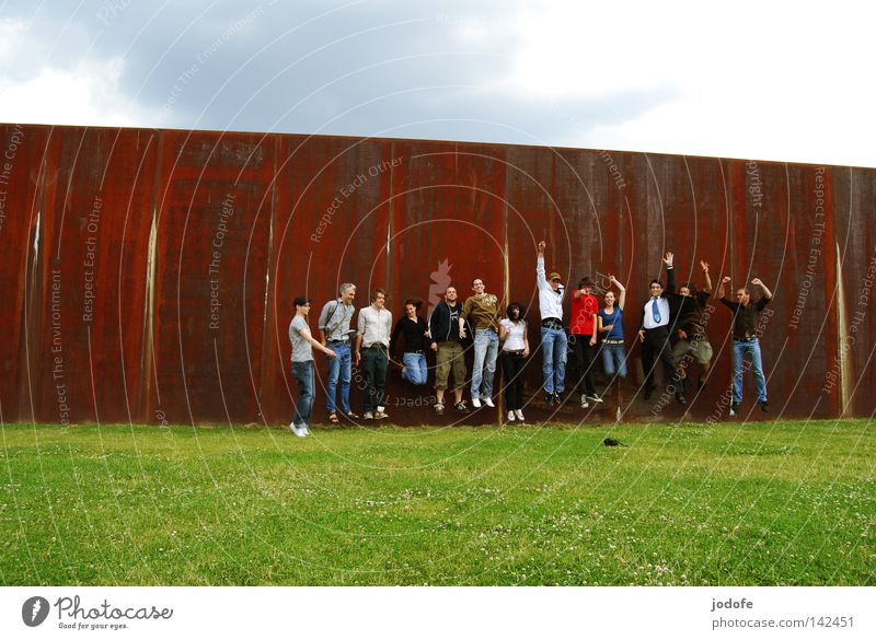 Bln 08 Jump. Group Meadow Wall (barrier) Happiness Joy Absurdity Take a photo Photographer Woman Man Human being Clouds Beautiful weather Physics Hot Sun