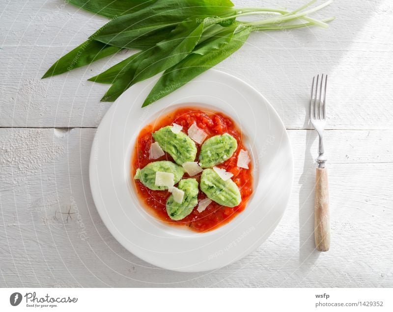 Gnocchi with wild garlic in tomato sauce and Parmesan cheese Vegetarian diet Plate Green Red White cam dumplings Torpedo noodles butter dumplings Club moss