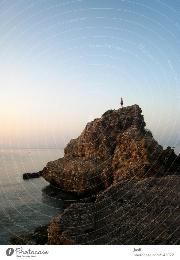 morning mood Ocean Sunrise Sunbathing Kitsch Romance Beautiful Human being Physics Pink Buoy Dress Woman Joy Sand Rock Stone Feasts & Celebrations Warmth Blue