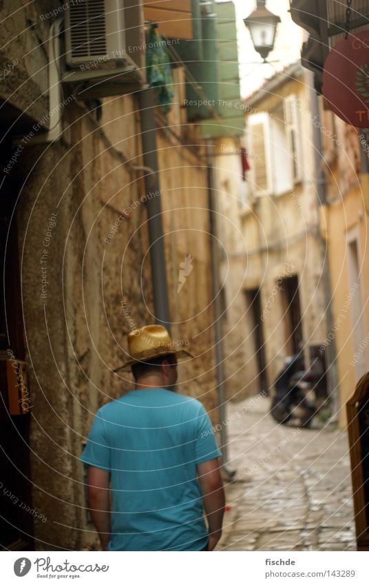 Man with hat Town To go for a walk Alley Narrow Small Vacation & Travel Lantern Window Wall (barrier) House (Residential Structure) Straw hat T-shirt Calm