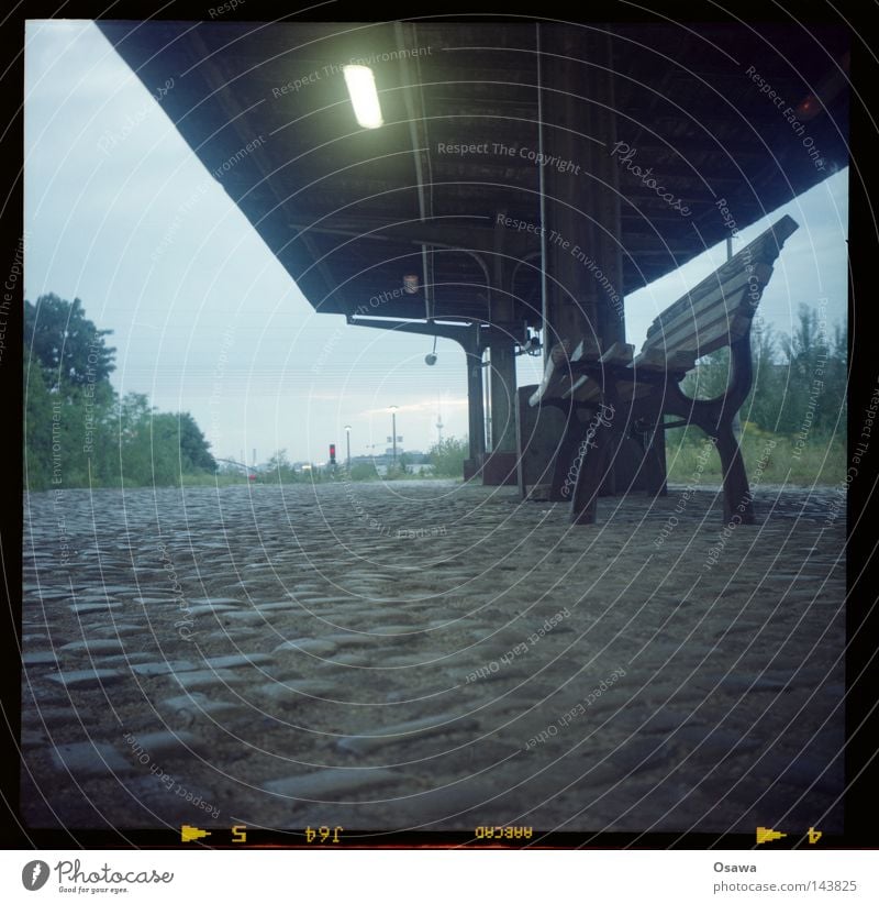 East Cross 12 Medium format Train station Platform Friedrichshain Cobblestones Roof Bench Park bench Lamp Light Fluorescent Lights Evening Old Commuter trains