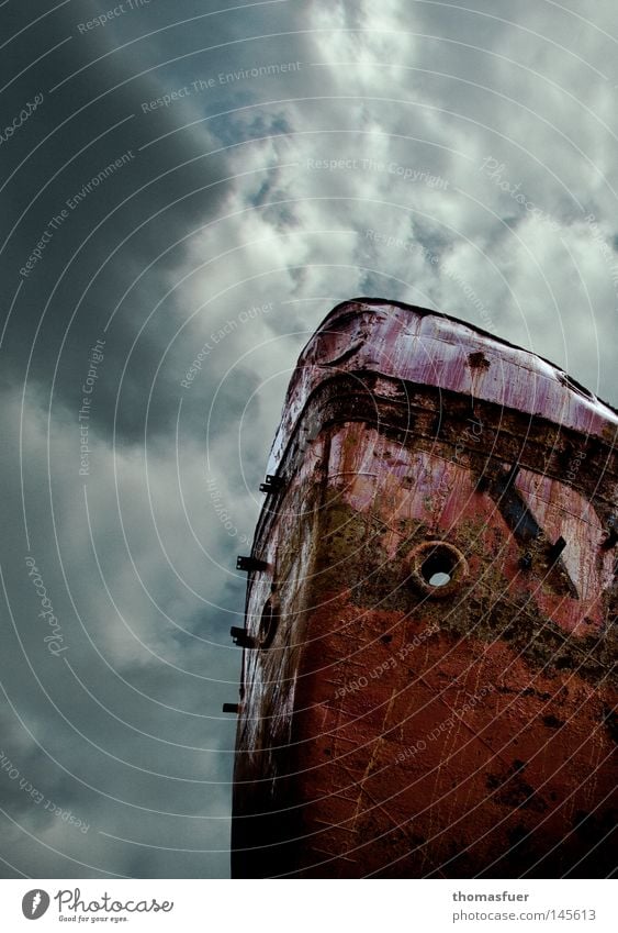 rusty ship bow in front of stormy sky Watercraft Old Rust Wreck Go under Hope Hopelessness Navigation Colour Paints and varnish Bow Sky Clouds Menacing Gale