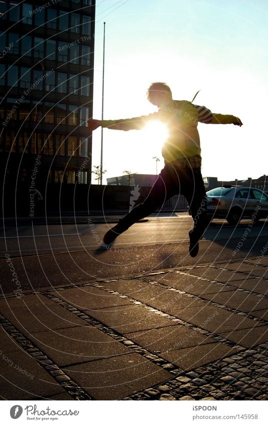 jumping spoon Man Jump Legs Feet Ground Paving tiles Street Cycle path High-rise Sunset Town Copenhagen Denmark Bridge Evening Tall Sky Blue Yellow Black Orange