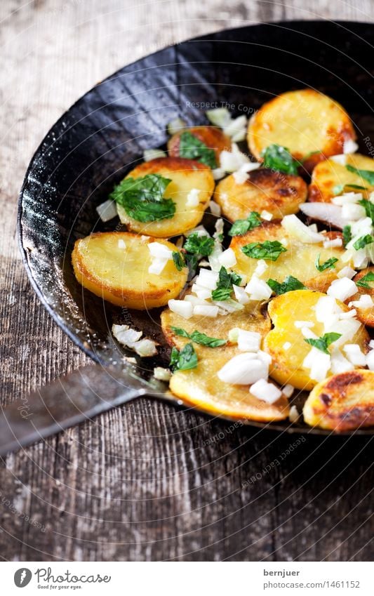 Fried potatoes in an iron pan Vegetable Herbs and spices Wood Fresh Cheap Good Potatoes Roasted Crisps Potato dish potato side dish Side dish Onion onion cubes