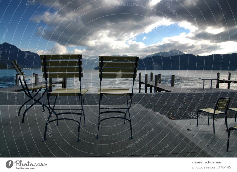 Low season at Lake Lucerne Autumn Chair Calm Water Mountain Alps German Alps Swiss Alps Light Shadow Switzerland Vantage point Loneliness Clouds Sky Yellow Blue