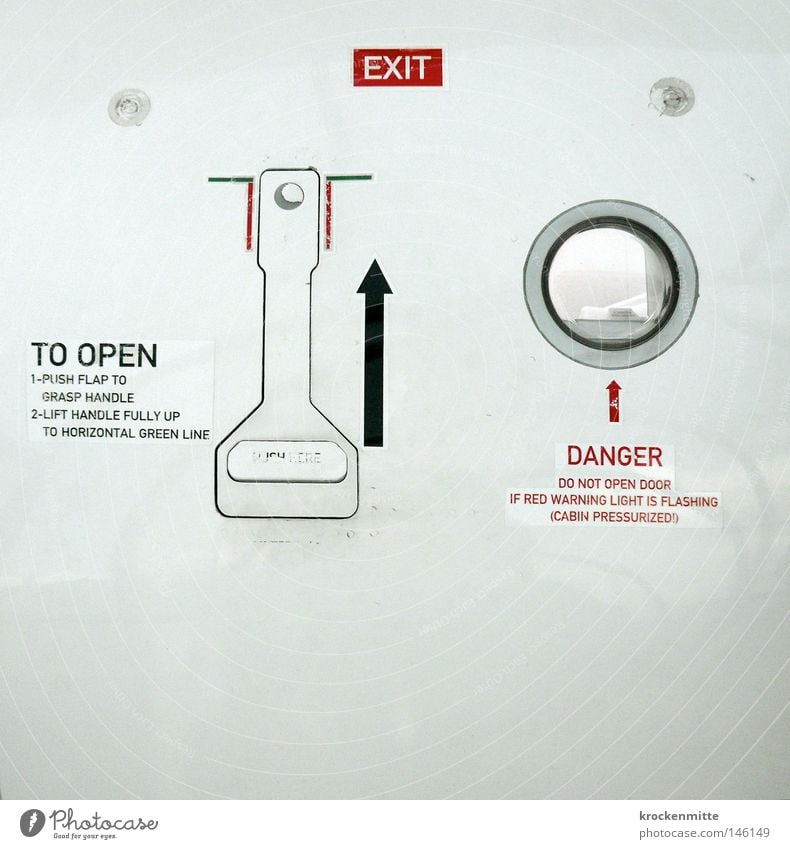 E X I T Airplane Way out Dangerous Circle Window Lever Red White Undo Emergency exit Flying Vacation & Travel Travel photography Fear Arrow Black