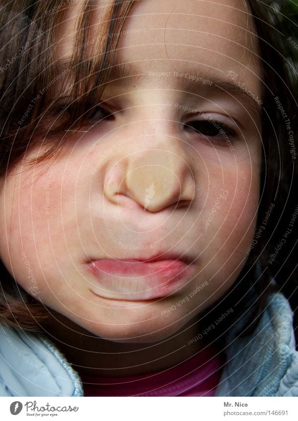 wittily Girl Child Grimace Tip of the nose Cheek Lips Pushing Forehead Make-up Joke Joy Funny Bursting Effort portrait Window pane Curiosity Head Face face Nose