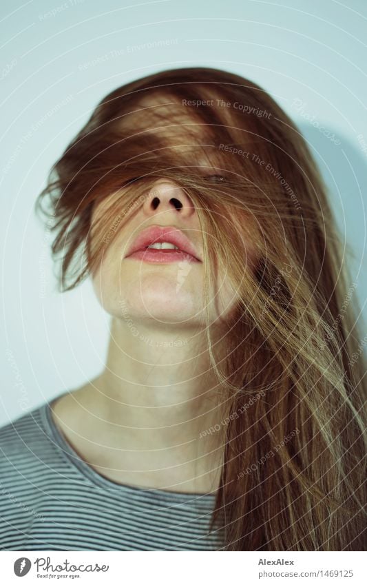 Portrait of a dark blond, long-haired woman looking into the camera through the hair on her face Lifestyle Style pretty Young woman Youth (Young adults)