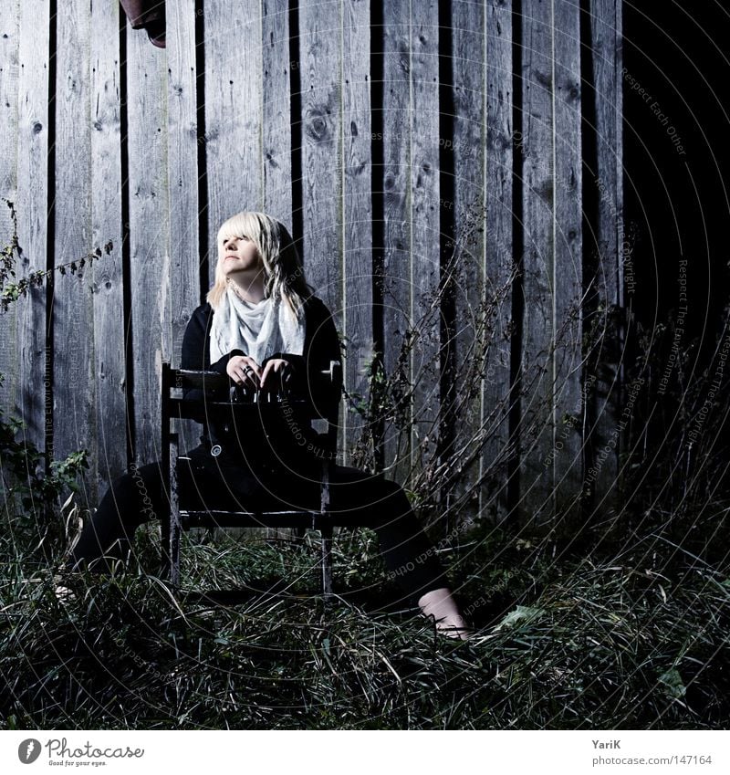 dark spot Woman Wall (building) Wall (barrier) Barn Wood Wooden board Cold Night Evening Dark Loneliness Photo shoot Portrait photograph Posture Light