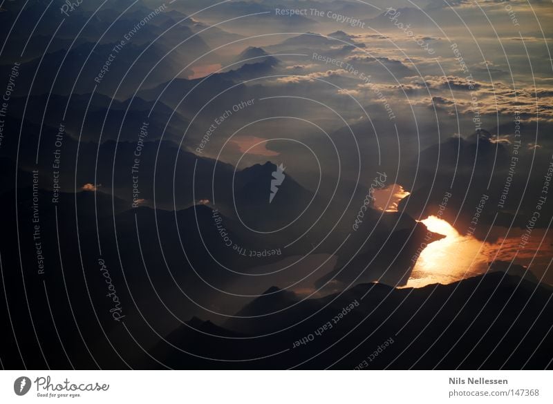 Over the Alps Airplane Clouds Height Lake River Red Evening sun Fog Gray Dark Mountain Panorama (View) Sunbeam Band of cloud Wisp of cloud Cloud cover