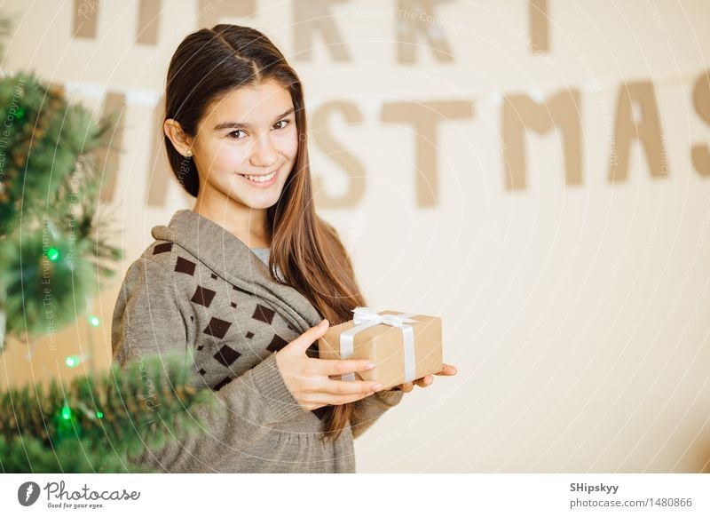 Little girl holding small gift and smile Beautiful Lamp Christmas & Advent Birthday Child Girl Sister Youth (Young adults) Face Eyes 1 Human being 13 - 18 years