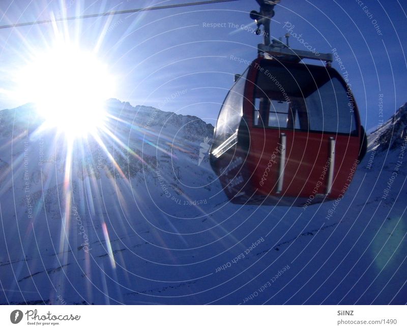 towards the sun Cable car Austria Winter Back-light Europe Snow Sun Mountain Stubaital Gondola Sunbeam Sunlight Radiation Luminosity Blooming Beautiful weather