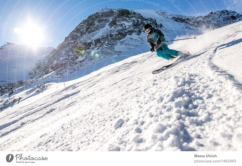 skier Sports Winter sports Skiing Skis Ski run Masculine 1 Human being Environment Nature Landscape Cloudless sky Sun Sunlight Beautiful weather Snow Hill Rock