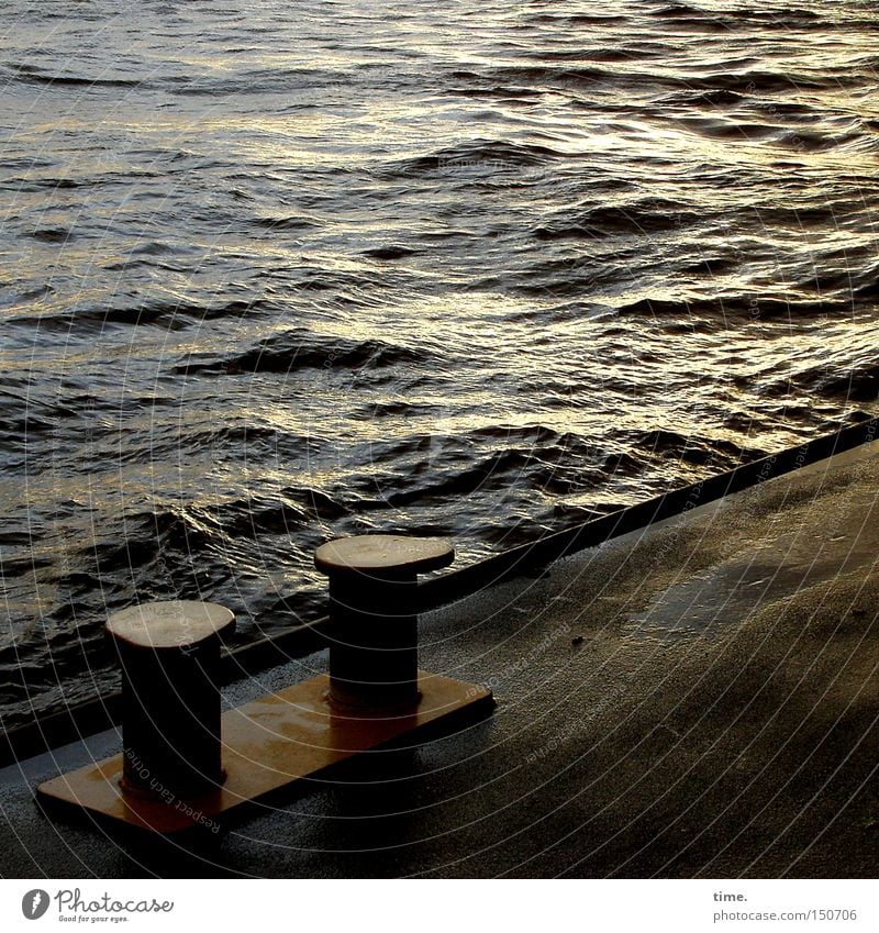 Last light on a cold day Waves Water River Harbour Navigation Sadness Jetty Bollard Asphalt Iron Elbe floating pontoon Evening Reflection Back-light Wet Gloomy