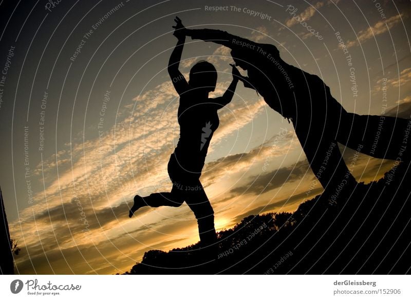 equilibrium moments Dance Back-light Sunset Light Contentment Calm Touch Black Yellow Sky Trust Concentrate Funsport Slacklining Exterior shot Balance Together