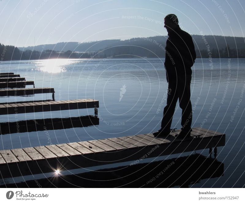 Winter rest Lake Footbridge Man Back-light Sun Moody Reflection Calm Blue Sky Water Cold December Mountain Landscape Peace Reflection & Reflection