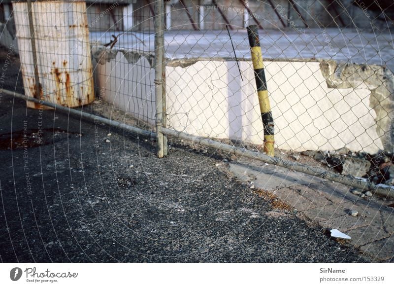 41 [street stories - restricted access] Construction site Wall (barrier) Wall (building) Authentic Broken Trashy Gloomy Fence Hoarding Evening sun Bright light