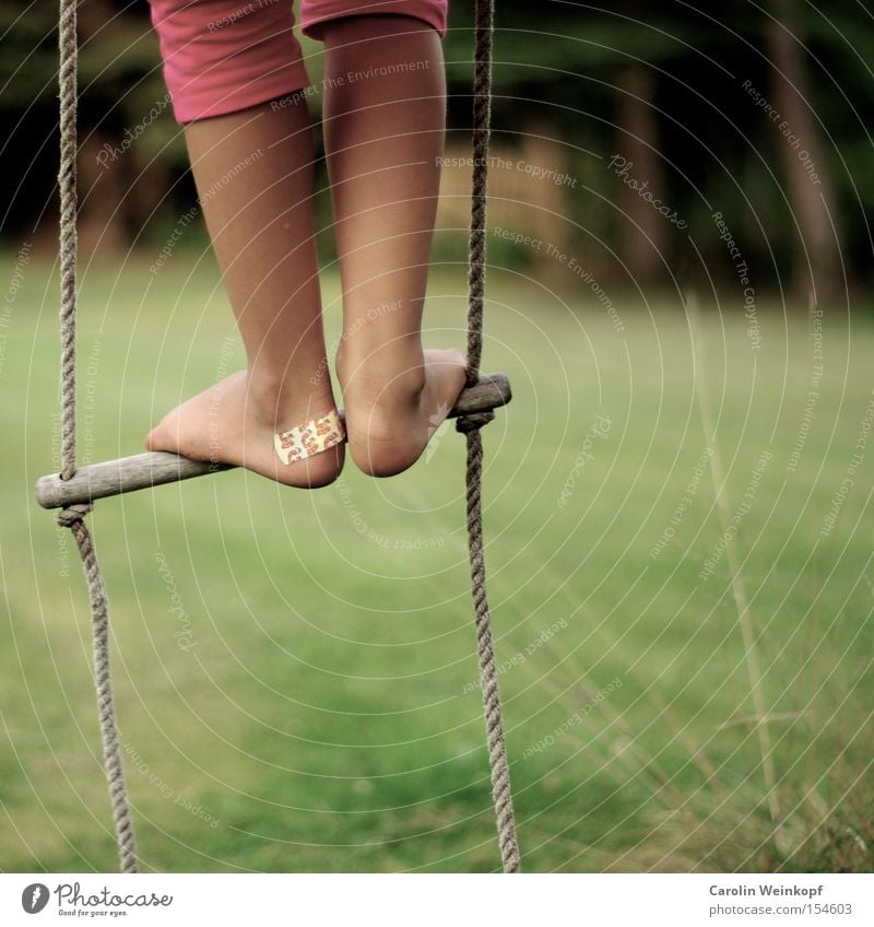 Back then. Joy Leisure and hobbies Playing Freedom Garden Climbing Playground Child Legs Feet Meadow Clothing Pants To swing Romp Rope ladder Wound Colour photo