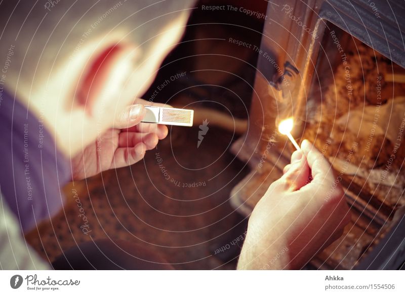 Young man lights a match to light the stove Human being Masculine by hand 1 Sign Illuminate Wait Ignite Fire Stove & Oven Attempt Snapshot Applause Colour photo