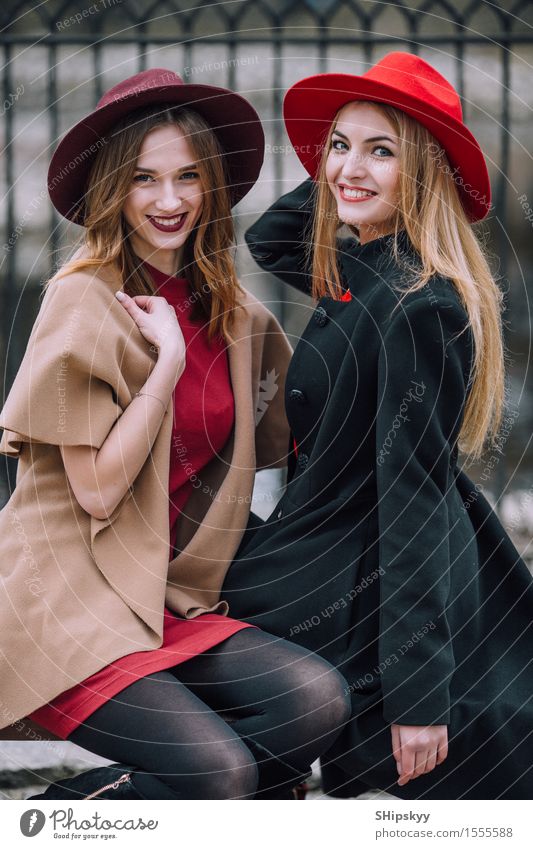 Two girls sitting on the bench and smile Lifestyle Joy Happy Beautiful Face Meeting Human being Feminine Woman Adults Friendship Autumn Fashion Hat Listening