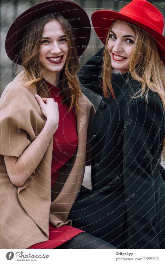 Two girls sitting on the bench and smile Lifestyle Joy Happy Beautiful Face Meeting To talk Human being Feminine Woman Adults Friendship Teeth Autumn Fashion