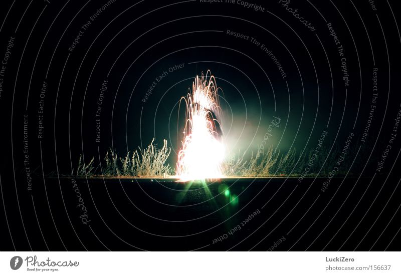 spontaneous ignition Water fountain Light Human being Frost Smoke New Year's Eve Turquoise Street Reflection Lens flare Bright Dark Explosion Beautiful Spark