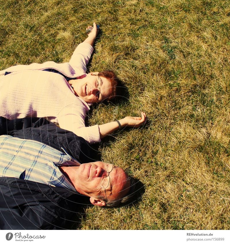 A couple of elderly people lying in a meadow Joie de vivre (Vitality) Meadow Lie Relaxation Human being Married couple To enjoy Summer Couple Laughter Happy