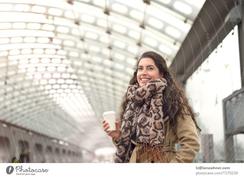 Smiling brown in winter coat holding a cup of coffee Coffee Happy Face Winter Woman Adults 1 Human being 18 - 30 years Youth (Young adults) Transport