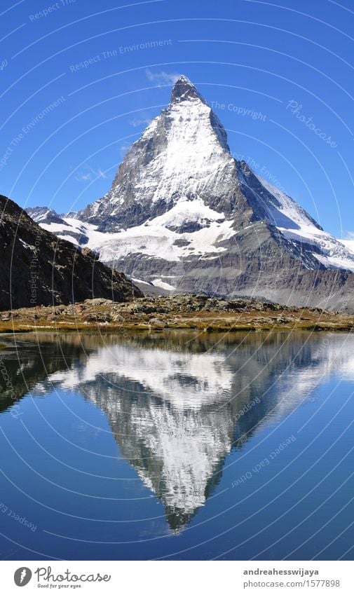 Matterhorn with mirror image Mountain Hiking Landscape Water Summer Beautiful weather Rock Alps Switzerland Peak Snowcapped peak Lake Mountain lake Nature