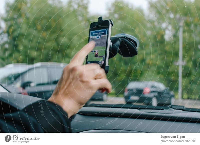 Mobile phone navigation in the car City trip Telephone Cellphone Human being Hand Fingers 1 Motoring Street Car Anticipation Serene Navigation Groundbreaking