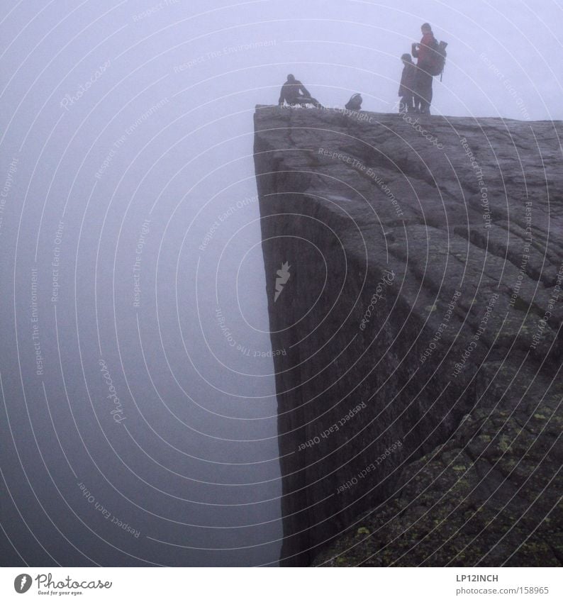 Preikestolen with wide view over the foggy Lysefjord Vacation & Travel Mountain Hiking Human being Fog To fall Lie Stand Threat Under Self-confident Power