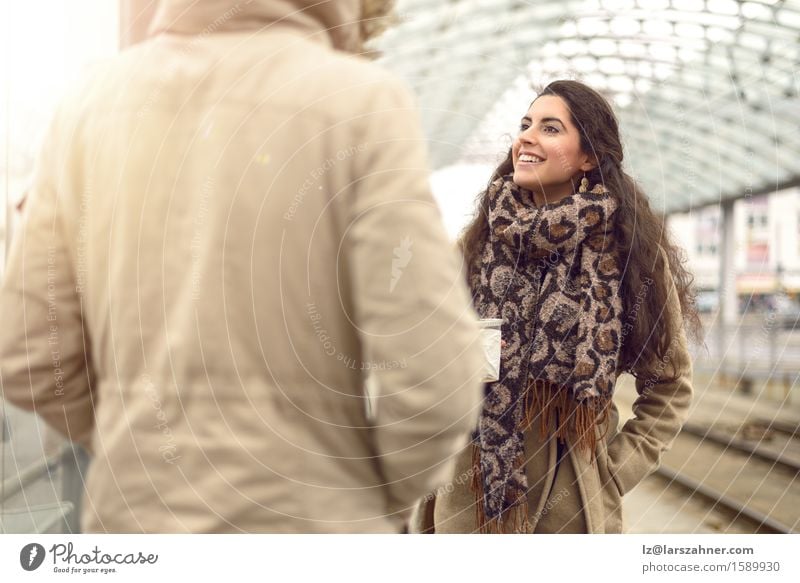 Pretty young woman with long brunette hair Beverage Face Winter To talk Woman Adults 2 Human being 18 - 30 years Youth (Young adults) Public transit Railroad