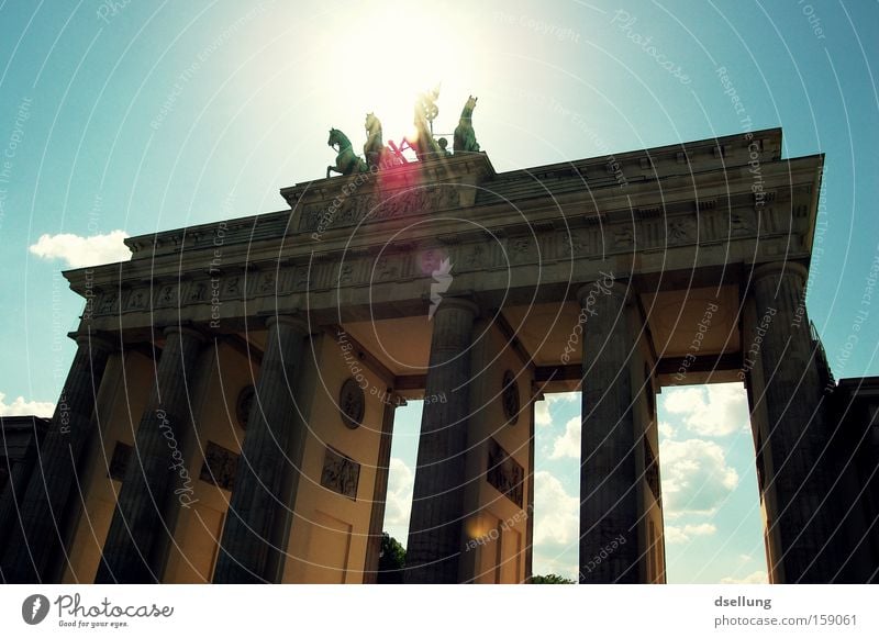 Brandenburg Gate against the light with blue sky Berlin Capital city Sun Summer Blooming Light Rider Carriage Horse Statue Monument Monumental Landmark Warmth