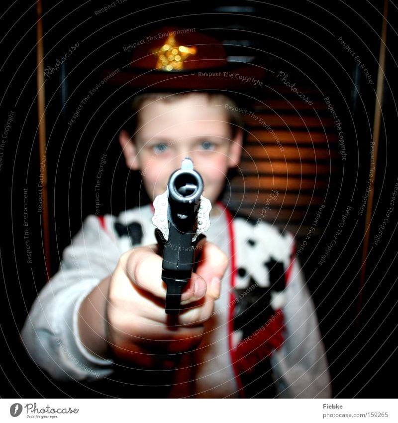 shooter Cowboy Duel Wild West Carnival Carnival costume Threat Boy (child) Child Tyranny Problem Playing Children's room problem child Joy Electricity Handgun