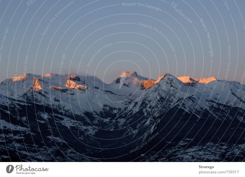 glowing mountains Mountain Peak Glow Red Evening Moody Alps Swiss Alps Snow Winter Vantage point Far-off places Twilight Level Dusk Switzerland