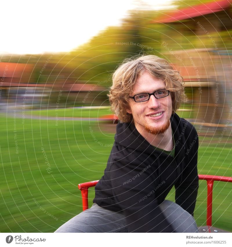 Young man spinning on a merry-go-round Human being Masculine Youth (Young adults) 1 18 - 30 years Adults Rotate Speed Joy Happy Happiness Contentment